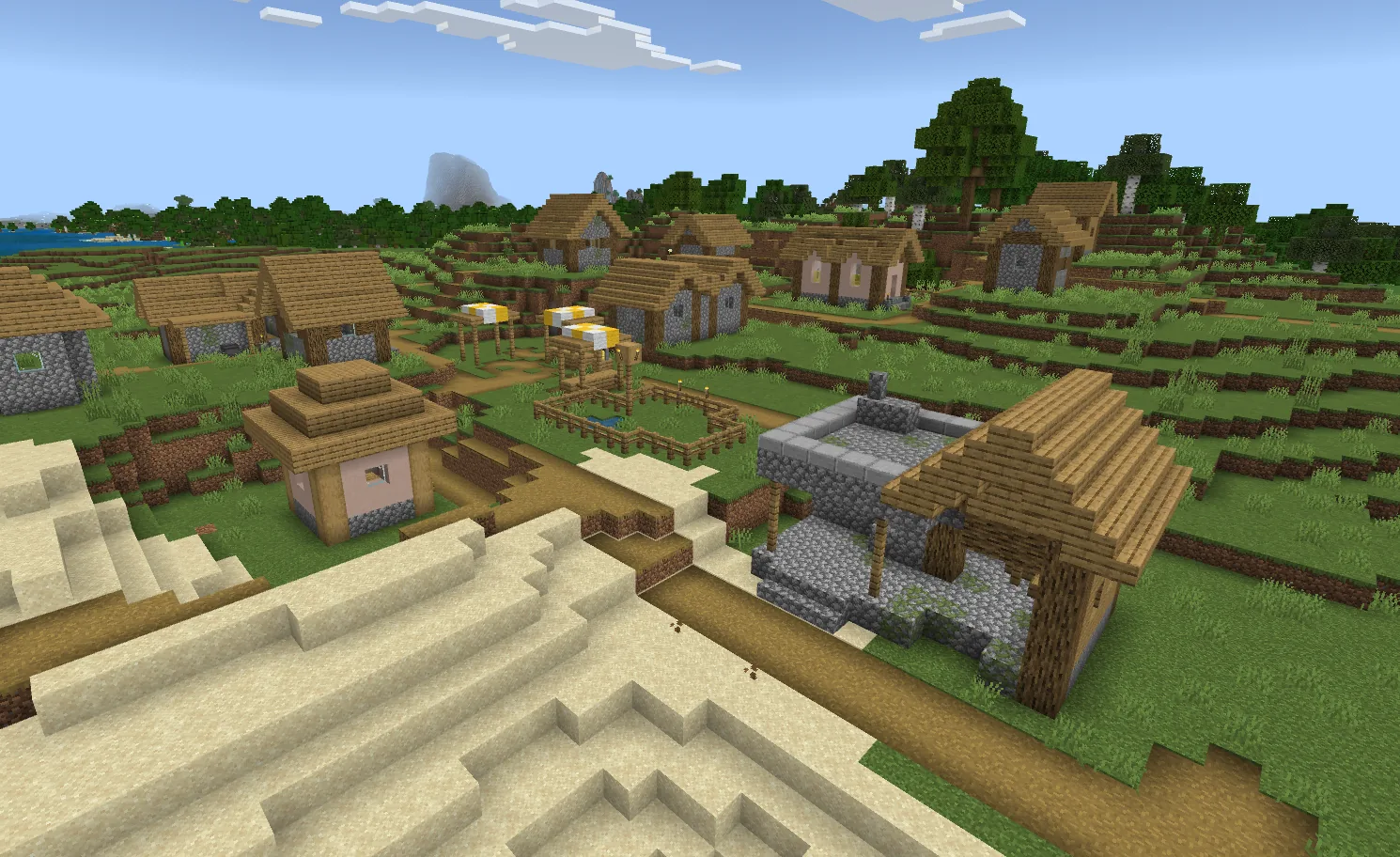 A Minecraft plains village with oak houses, a well, and villagers going about their day
