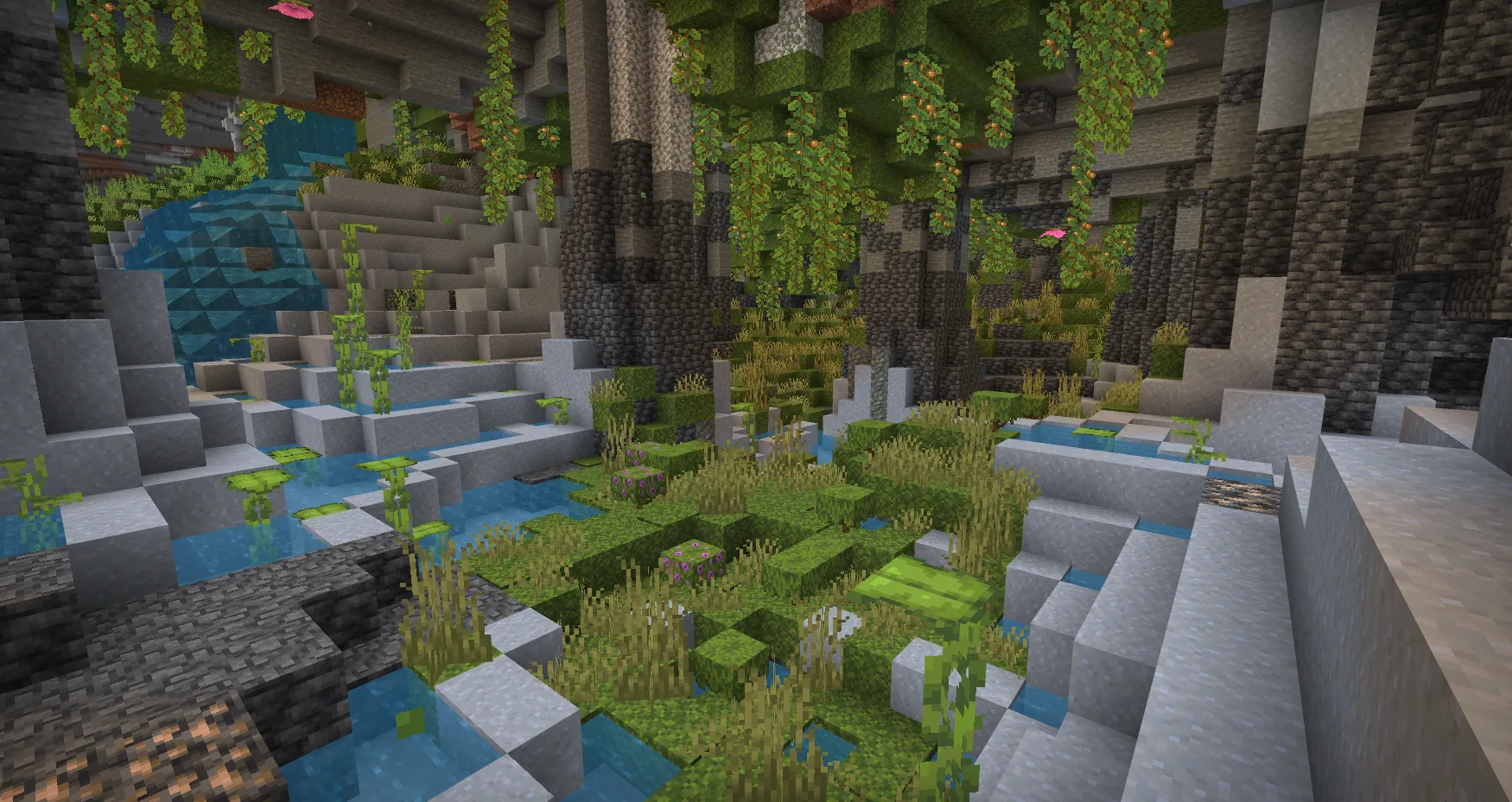 Inside a Minecraft lush cave showing moss floor, glow berries and azalea trees