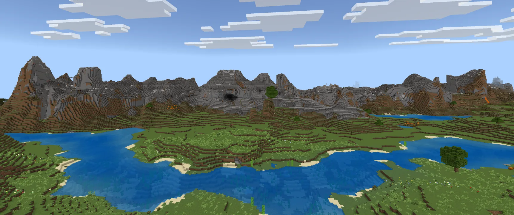 Plains biome with a stony peaks mountain range in the background