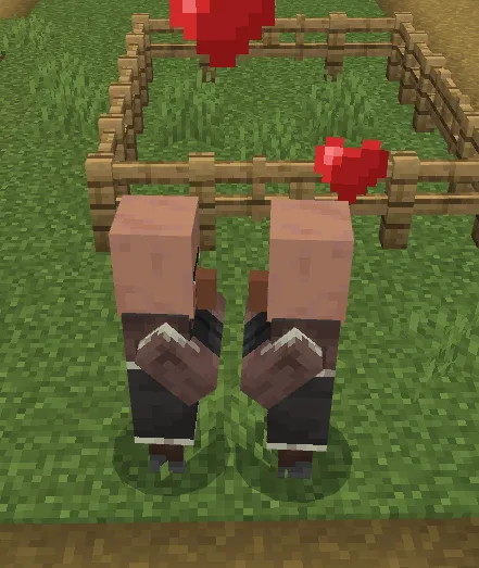 Two adult villagers surrounded by love hearts — a successful breeding pair in action